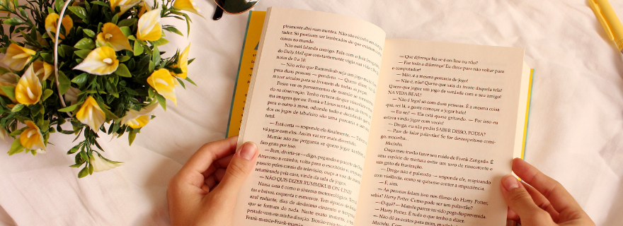 Open book next to flowers